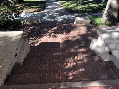 Before: Worn brick steps before repair