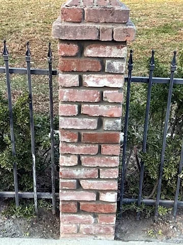 Brick pillar with iron fence