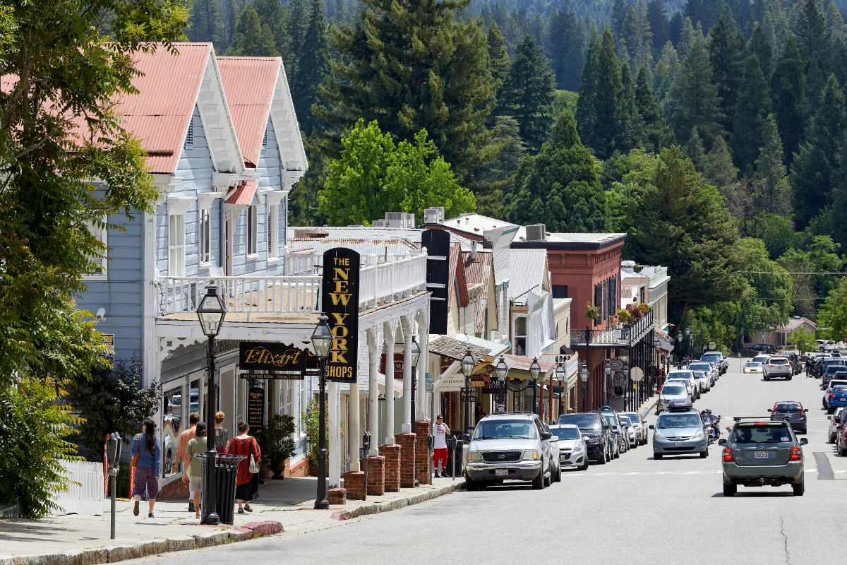 Historic Broad Street in Nevada City with Gold Rush era buildings and pine-covered hills